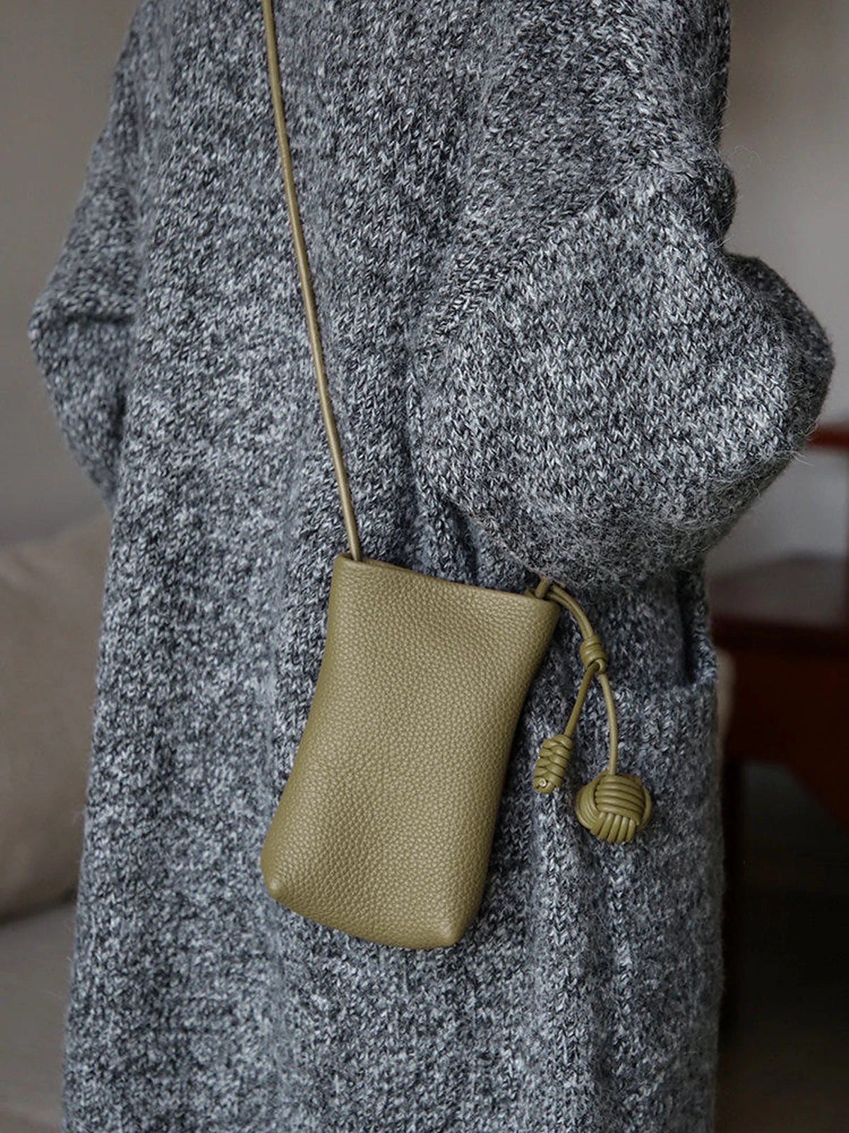 Sage Green leather phone pouch worn crossbody