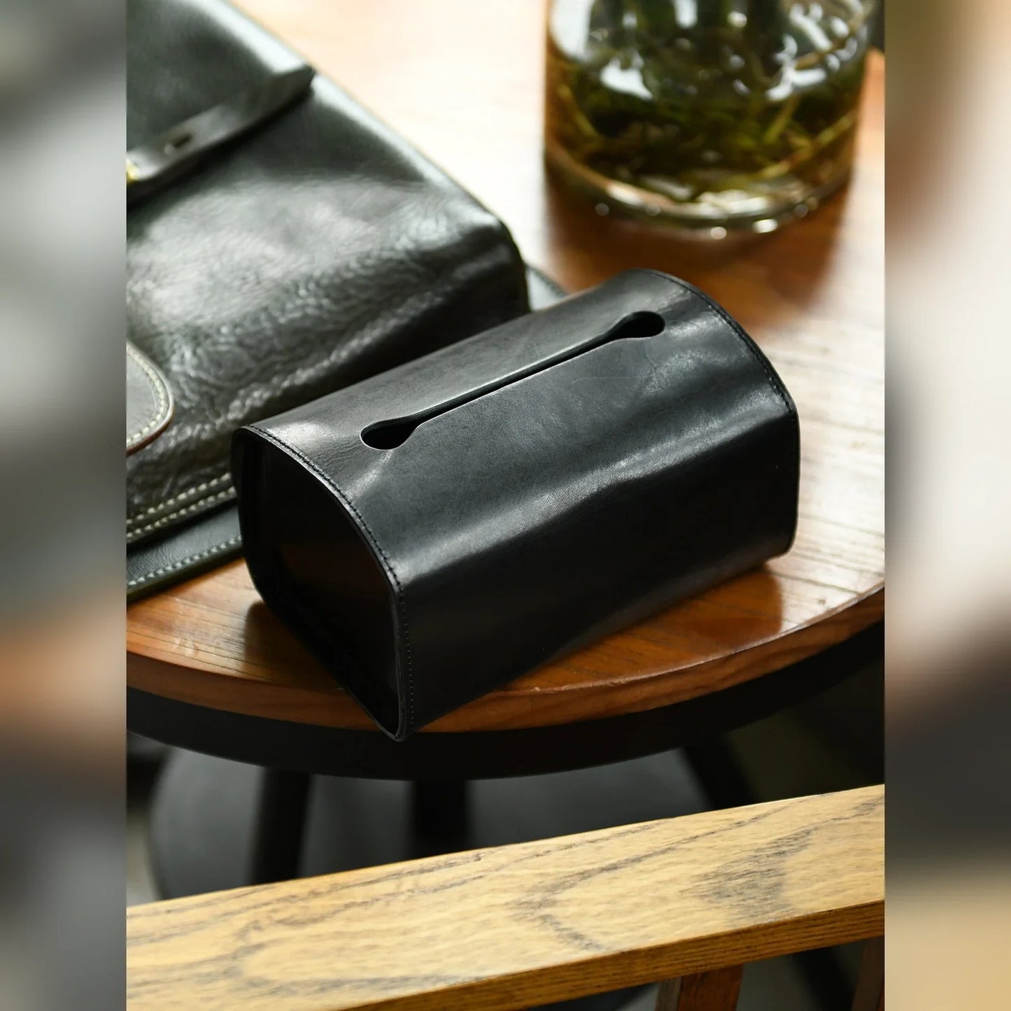 Black top-grain cowhide tissue box cover styled on a side table