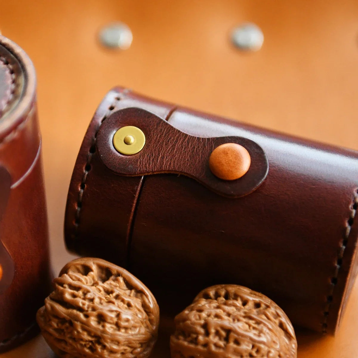 Top-grain leather cylindrical storage case styled with walnuts