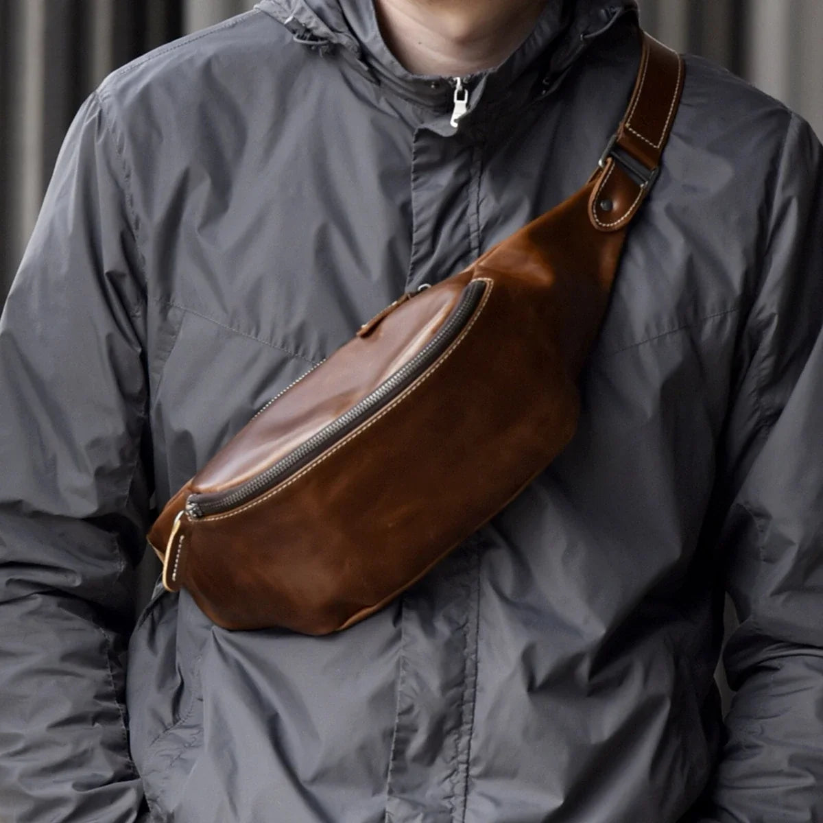 Top-grain leather crescent sling bag worn across the chest