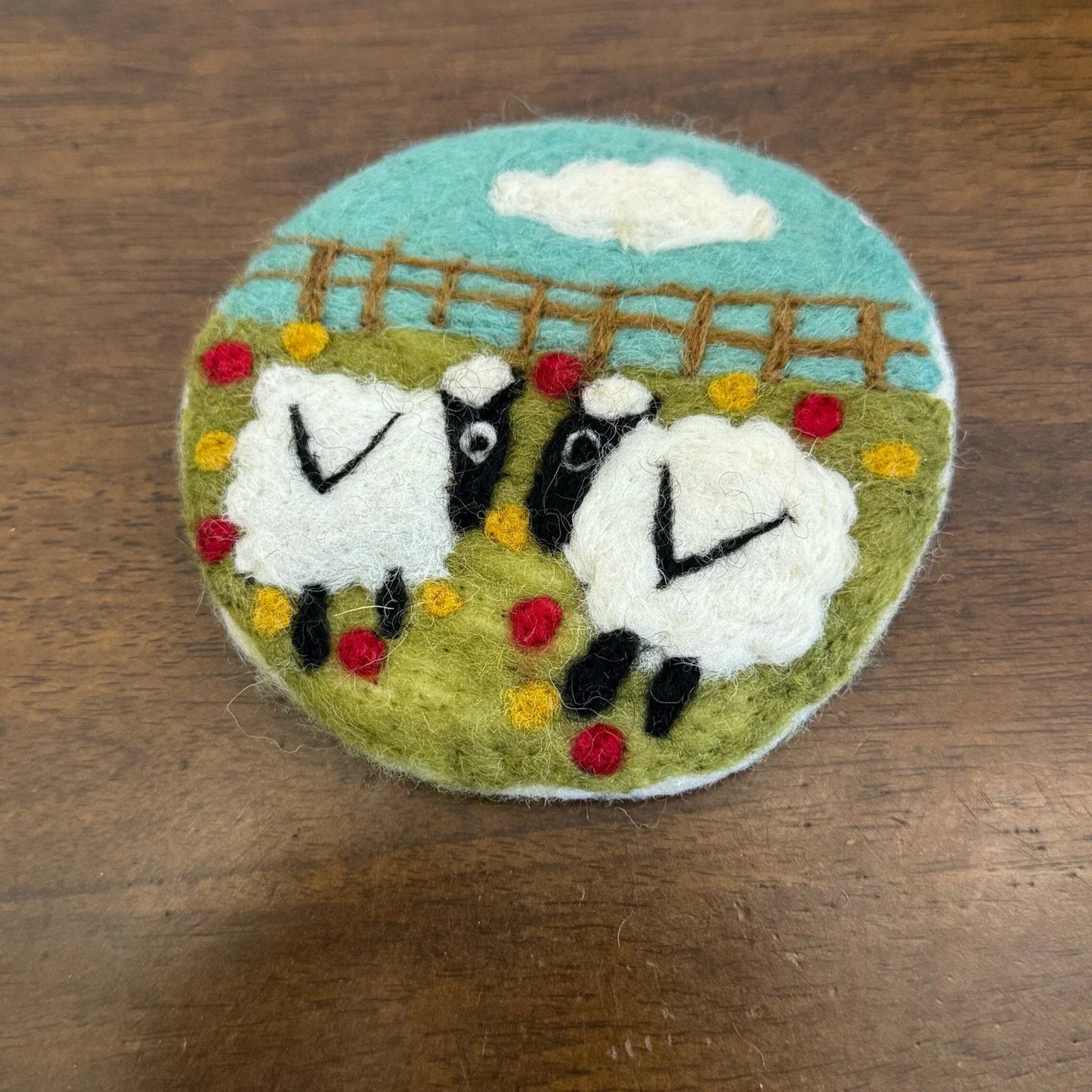 Two Sheep wool felt coaster with fence, flowers and blue sky