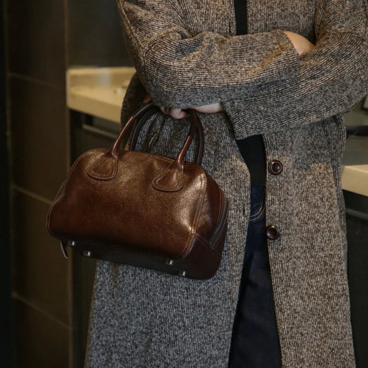 Ebony Brown vegetable-tanned cowhide bowling bag carried by top handles