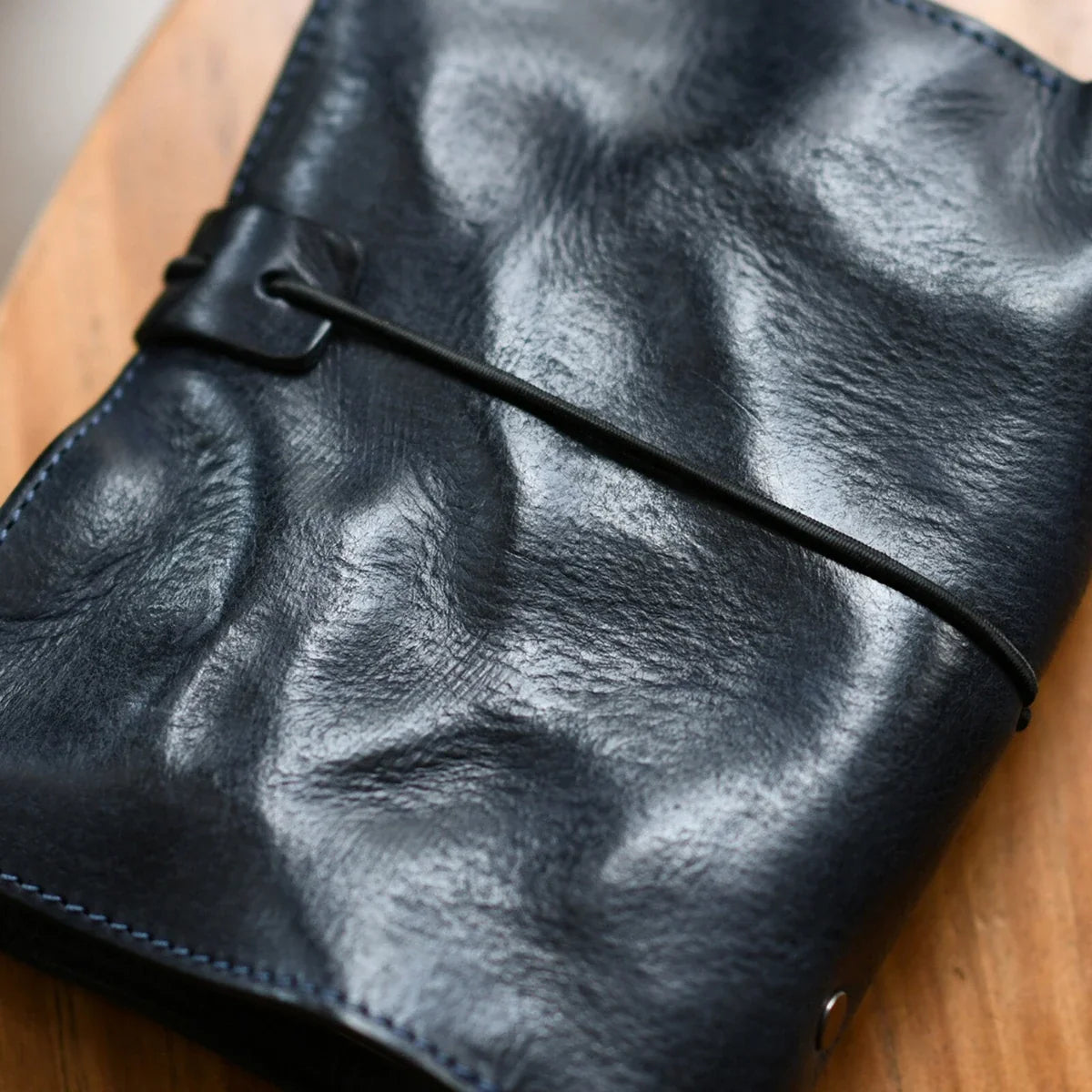 Close view of the leather grain and wraparound cord closure