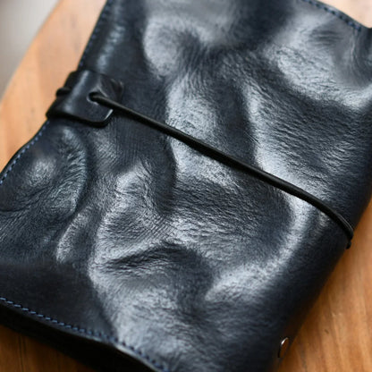 Close view of the leather grain and wraparound cord closure