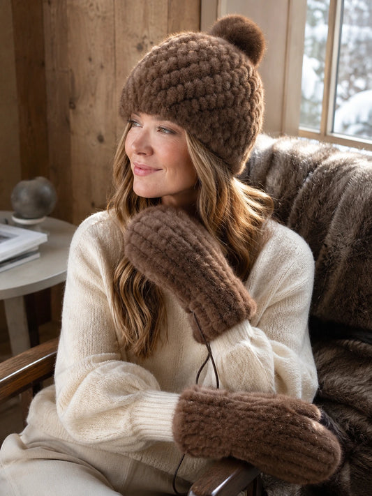 Woman styling the warm brown mink fur hat and mittens indoors