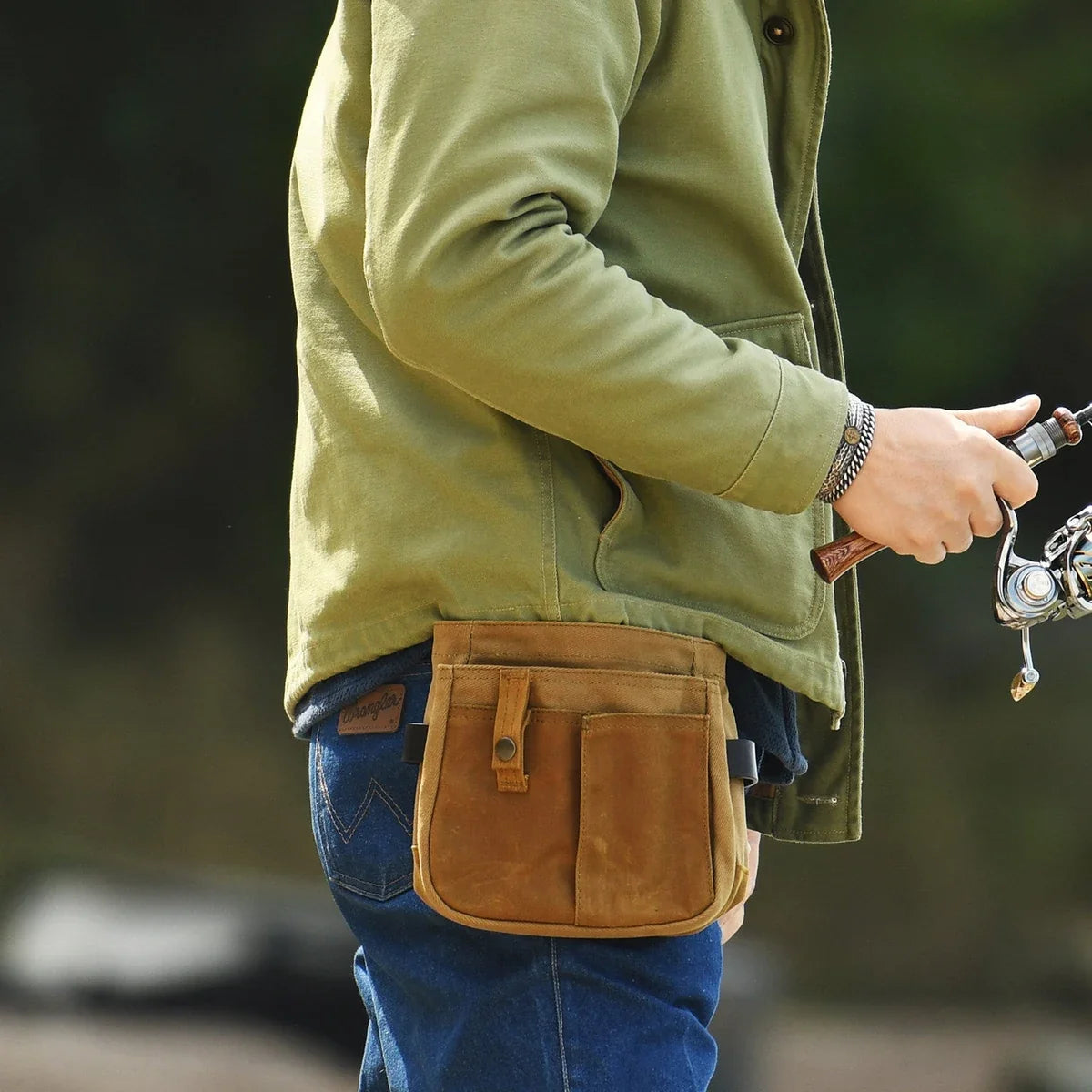 Khaki waxed canvas belt pouch worn while fishing