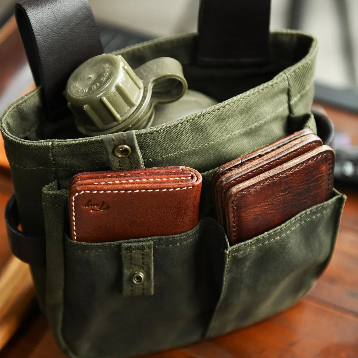 Multi-pocket waxed canvas tool pouch capacity detail