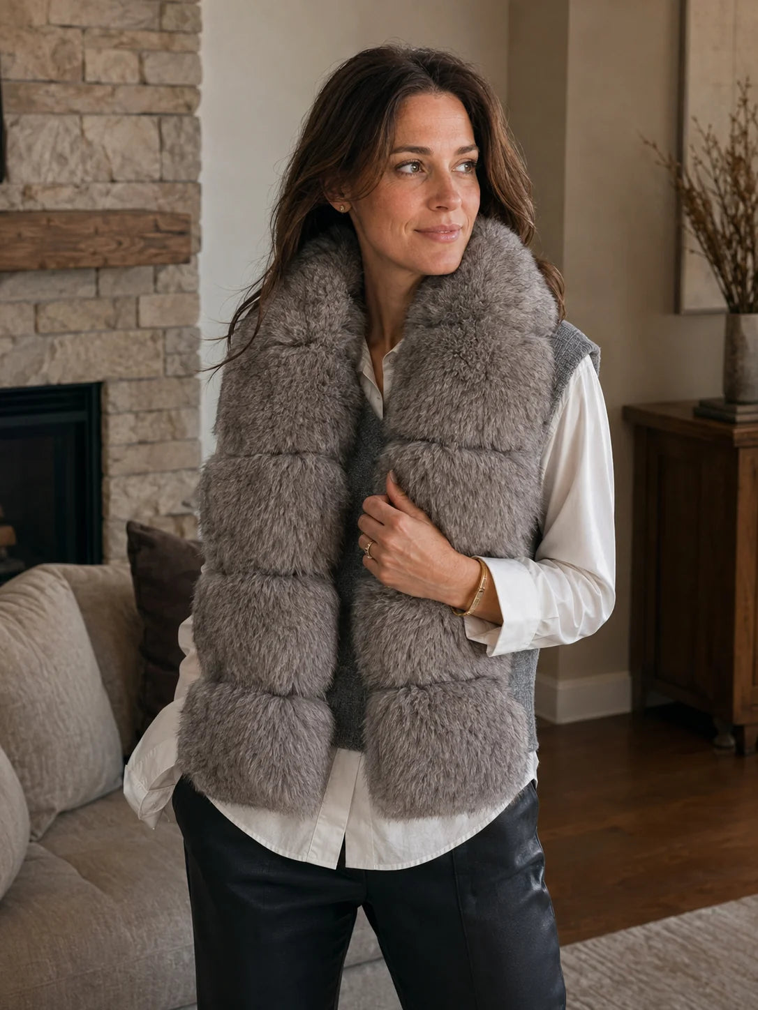 Woman wearing a gray taupe blue fox fur scarf inside a lodge