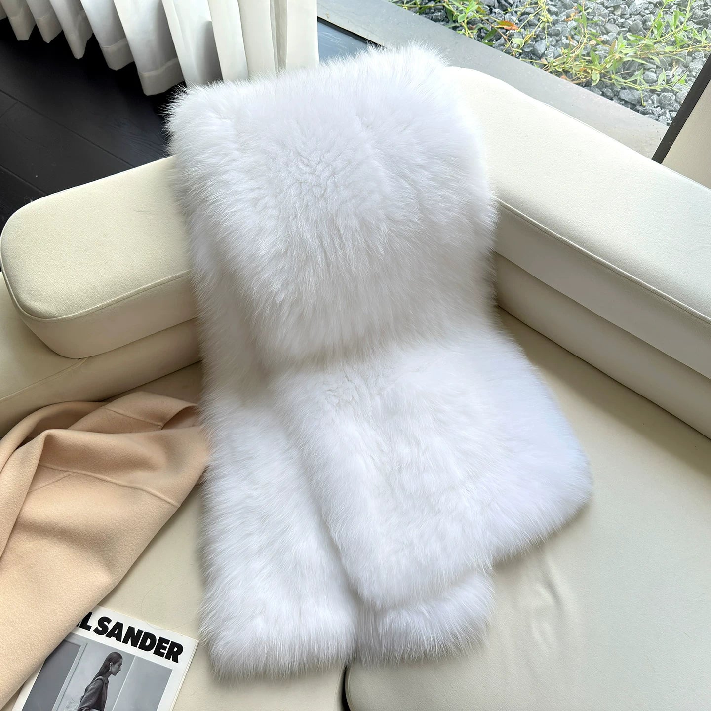 Ivory White genuine fox fur shawl arranged on a light chair