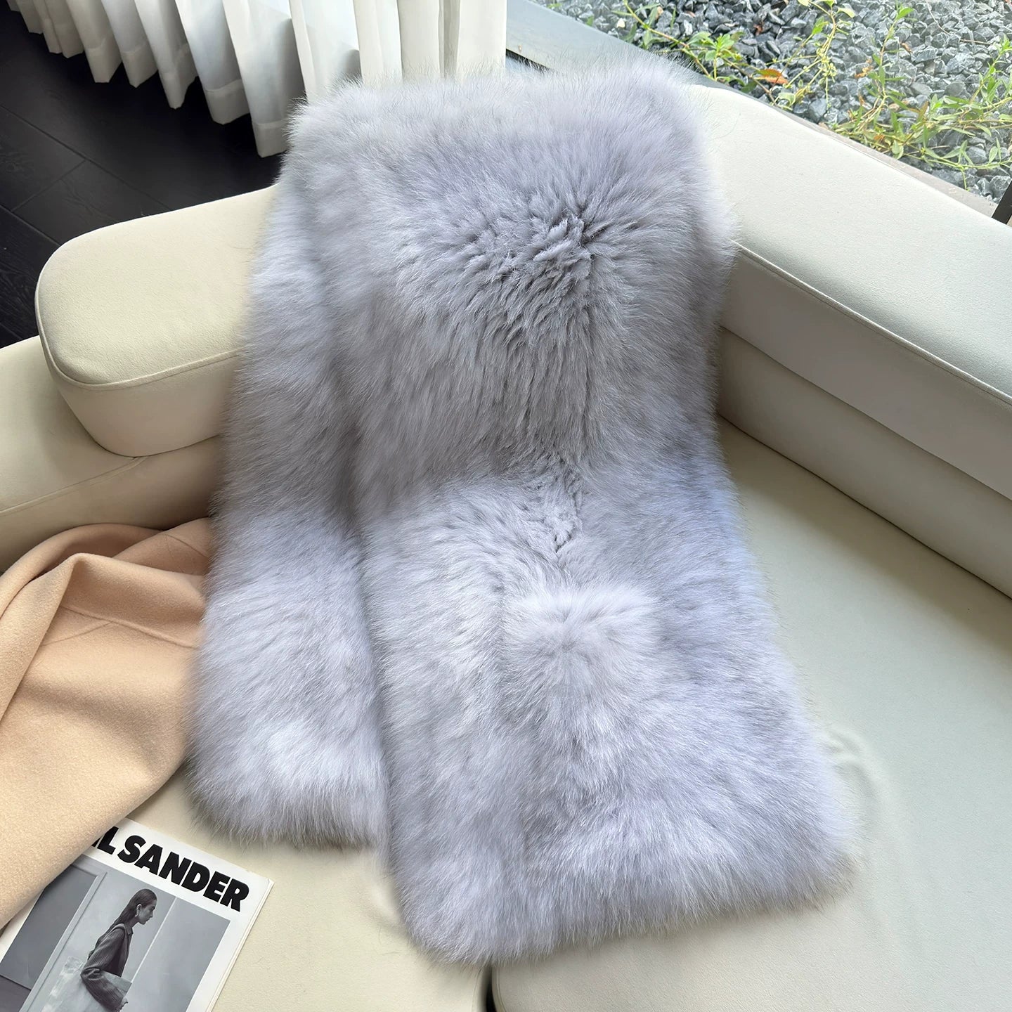 Silver Gray genuine fox fur shawl arranged on a light chair