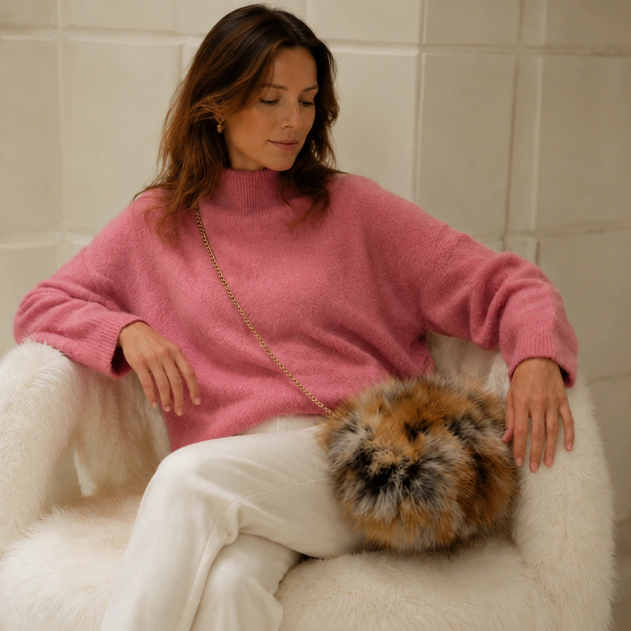 Red fox fur hand muff bag styled with relaxed winter knitwear