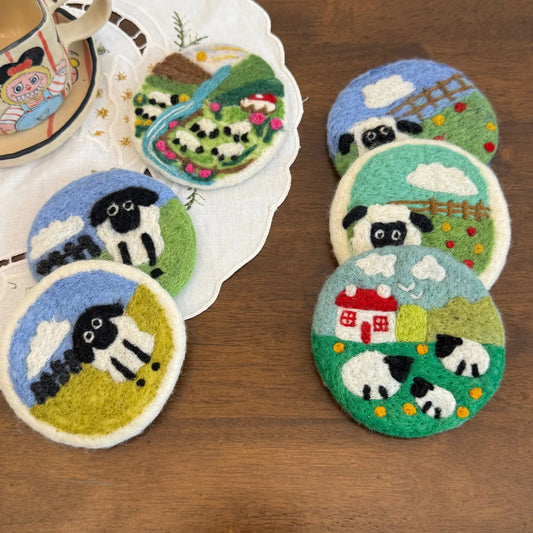 Collection of colorful pastoral wool felt coasters in a relaxed tabletop setting