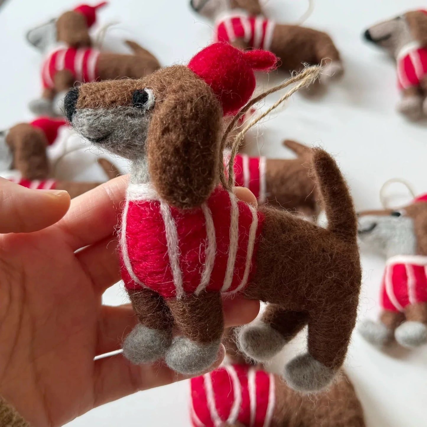 Close detail of the wool felt dachshund charm and hanging loop