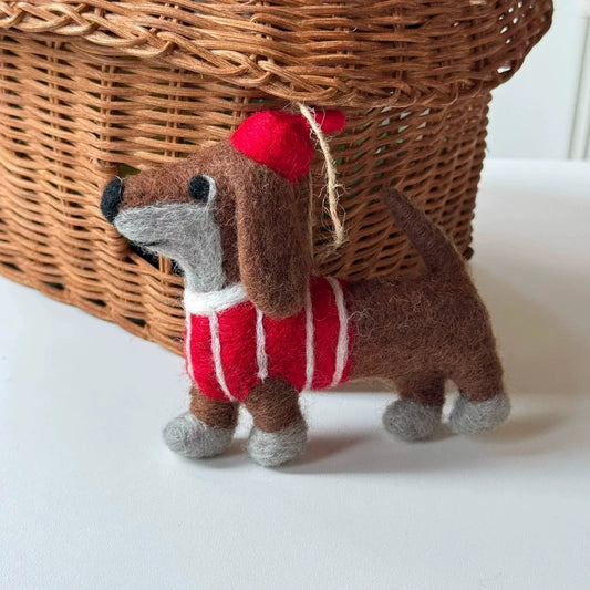 Full view of a brown wool felt dachshund charm in a striped sweater