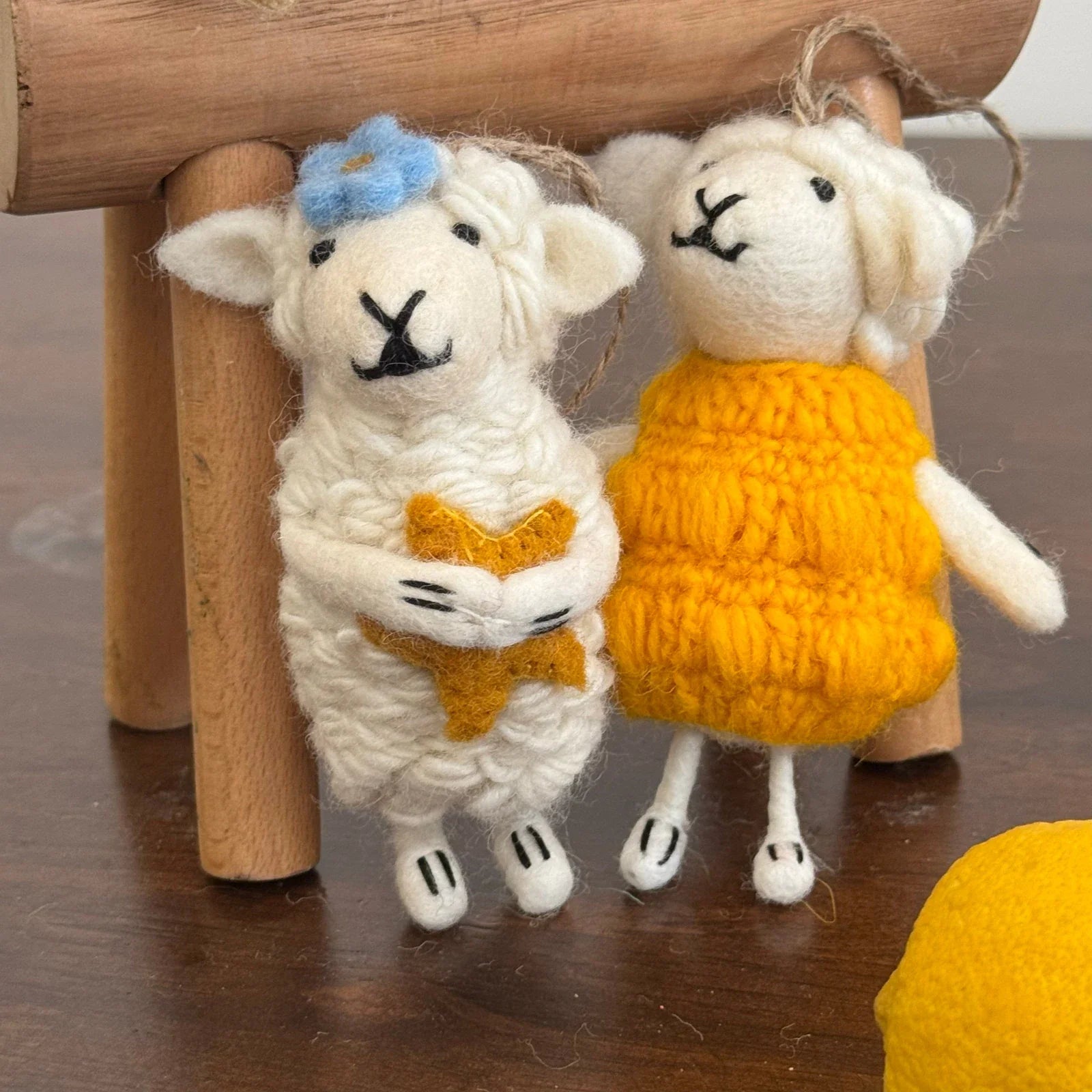 Two handmade wool felt sheep bag charms with textured wool details