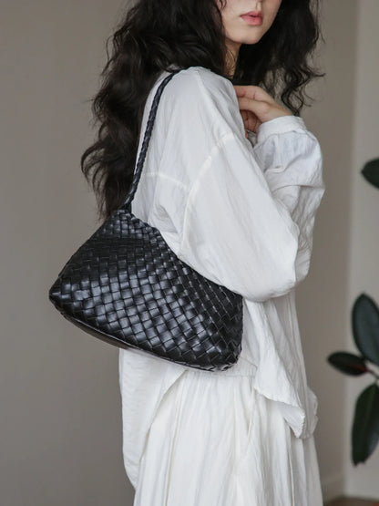 Black woven leather shoulder bag in side profile