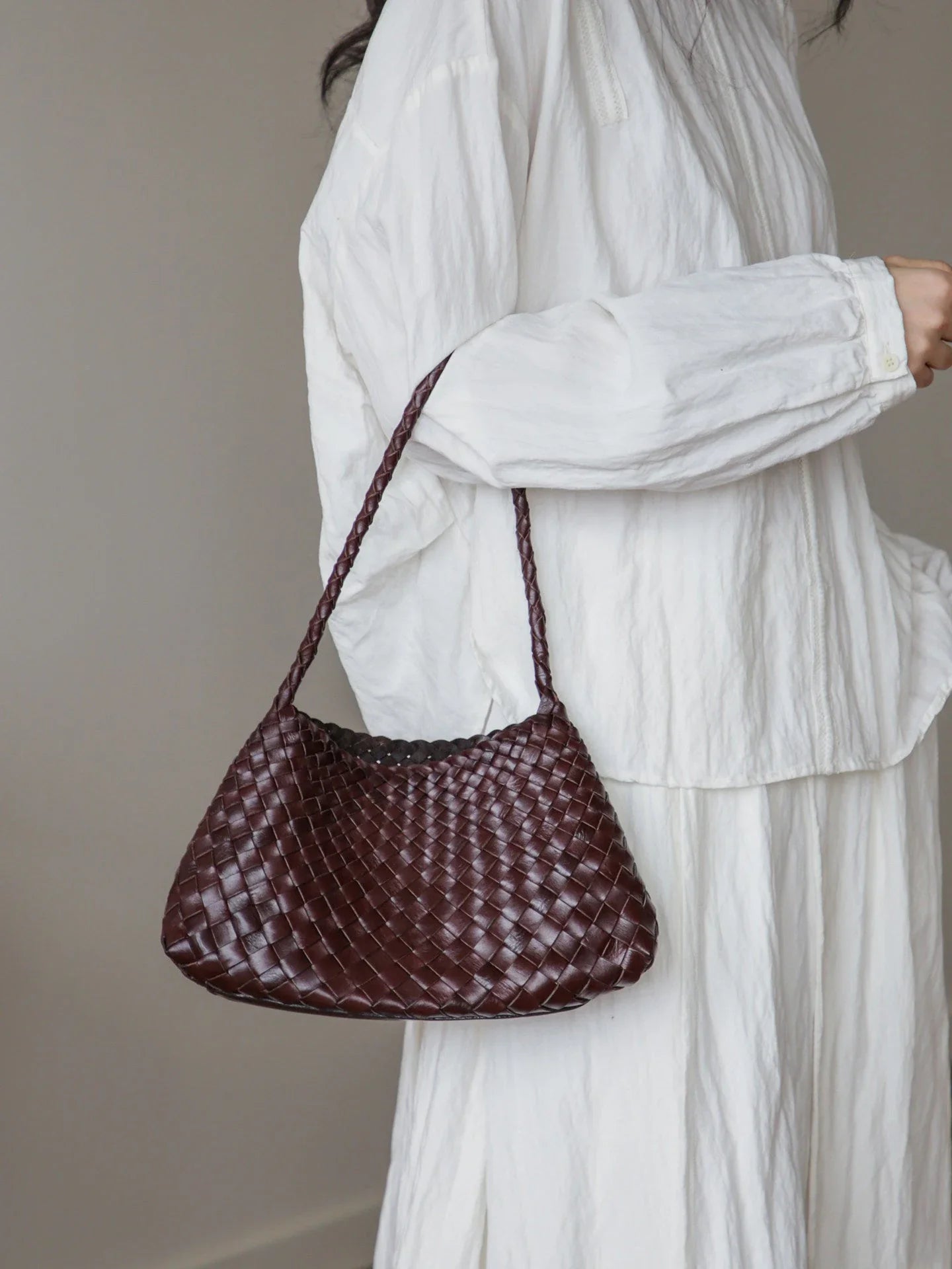 Coffee brown woven leather bag shown as a hand carry
